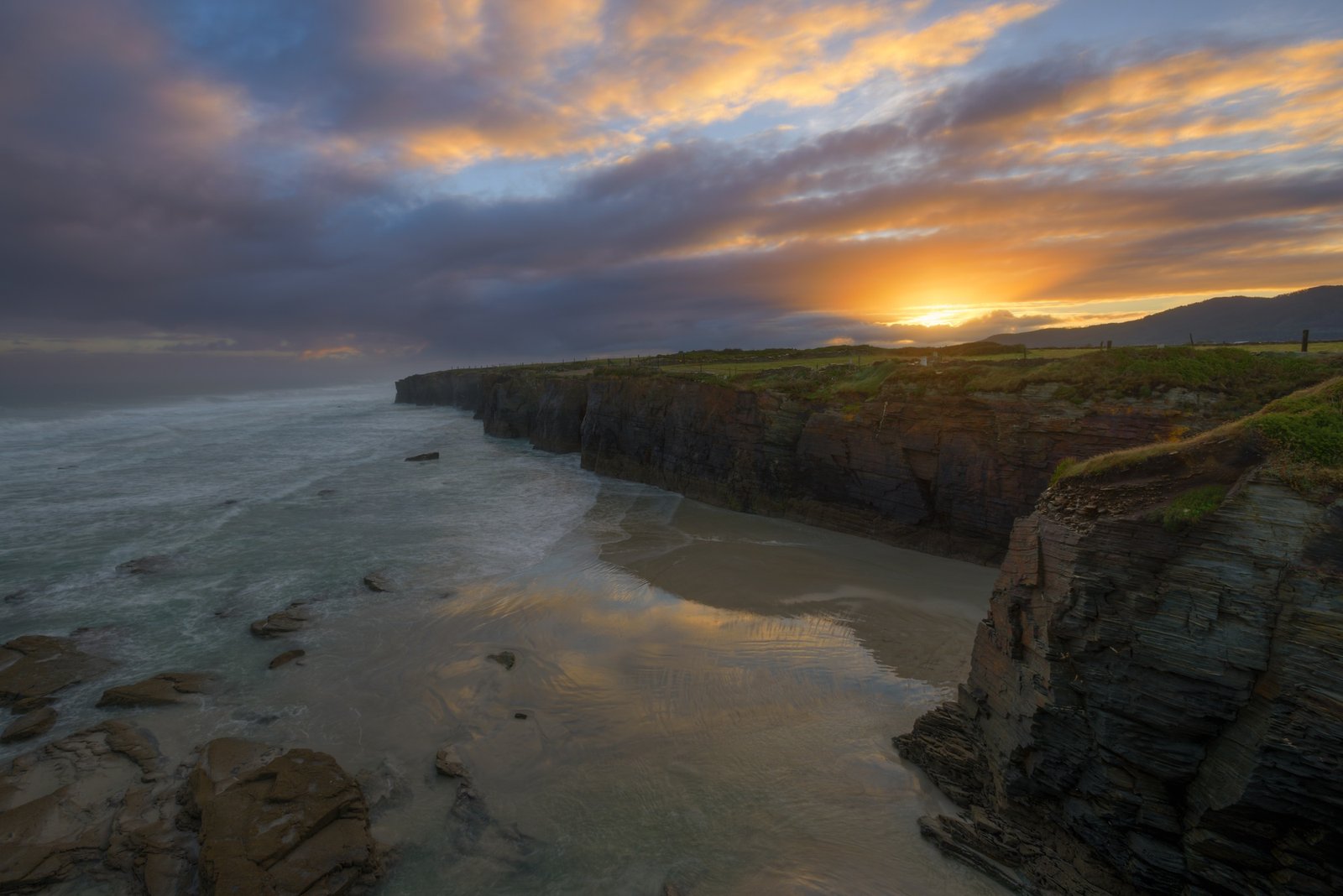 Golden clouds at dawn on the beach